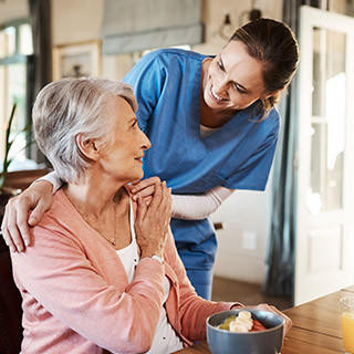 Elderly woman at home with nurse