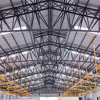 The interior of a big industrial building or factory with steel constructions