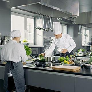 Busy kitchen, Chefs and Cooks working on their dishes.