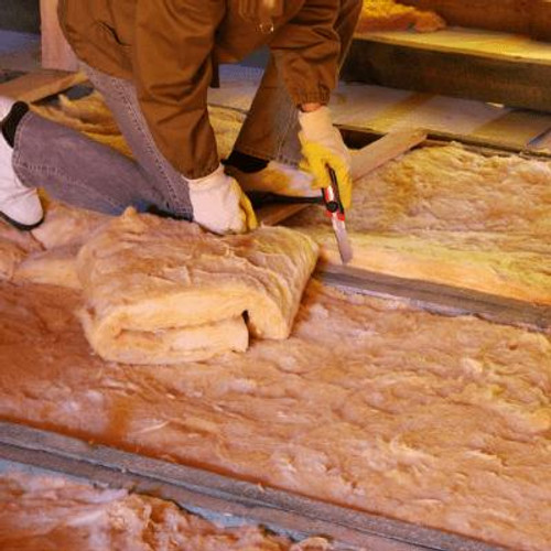 person installing insulation in a roof space.