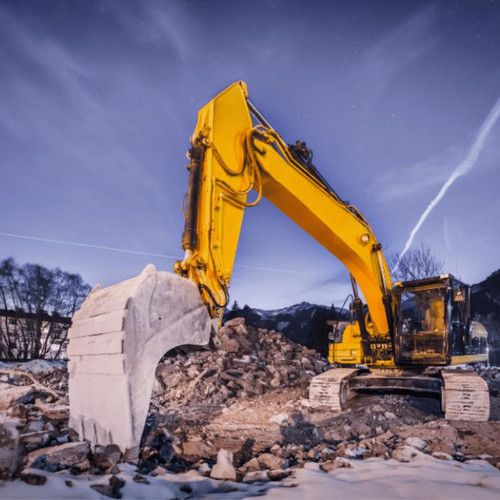 Excavator cleaning up a demolition site.