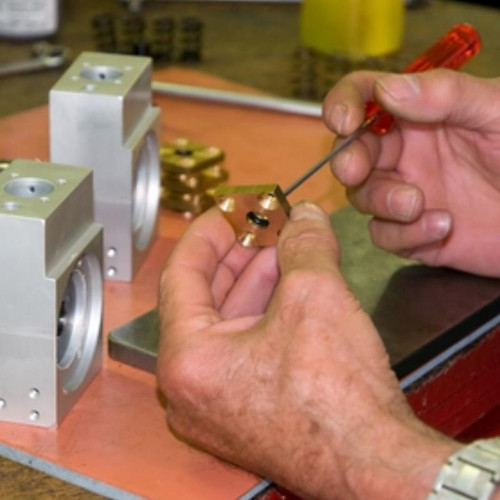 Man using a screwdriver assembling equipment.