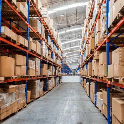 A large warehouse with isle shelving and boxes stacked cleanly.