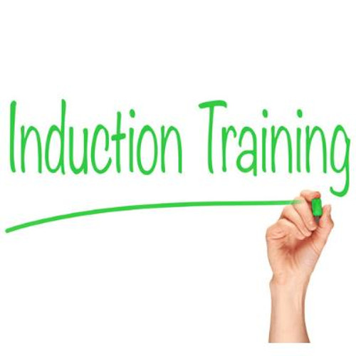 Person writing Induction Training.