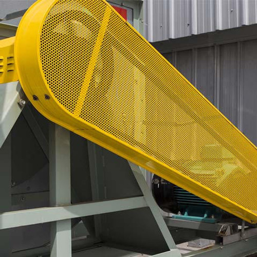 Large machinery with a large yellow guard protecting the rotator belt.