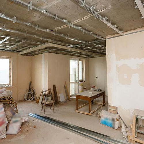 Installing metal profile ceiling during repair of shop fitting