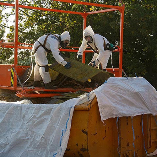 Two men in protective suits are removing asbestos cement corrugated roofing