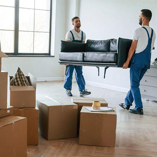 Two removalists moving furniture