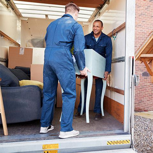 Removal company workers unloading furniture and boxes from truck