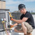 HVAC technician inspecting a condensing unit.