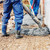 Worker laying cement or concrete with automatic pump
