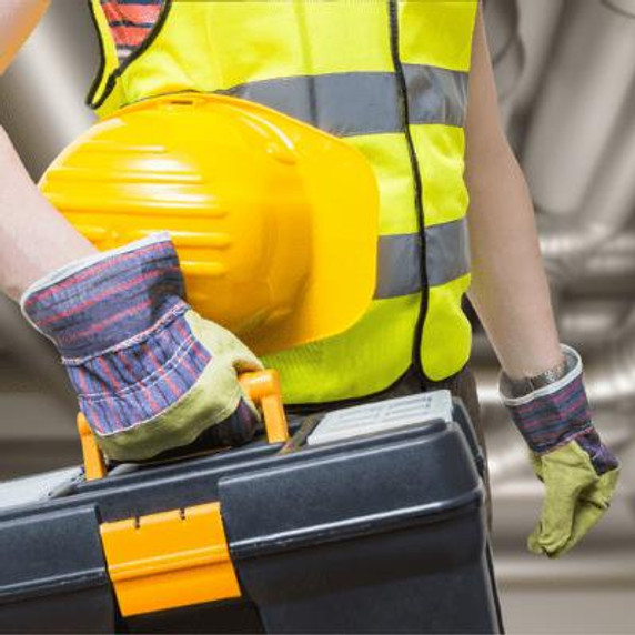 Person in yellow high-vis jacket and gloves carrying a tool box and hard hat