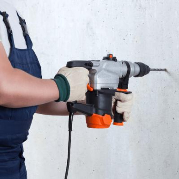 Man drilling a wall with a Hammer Drill