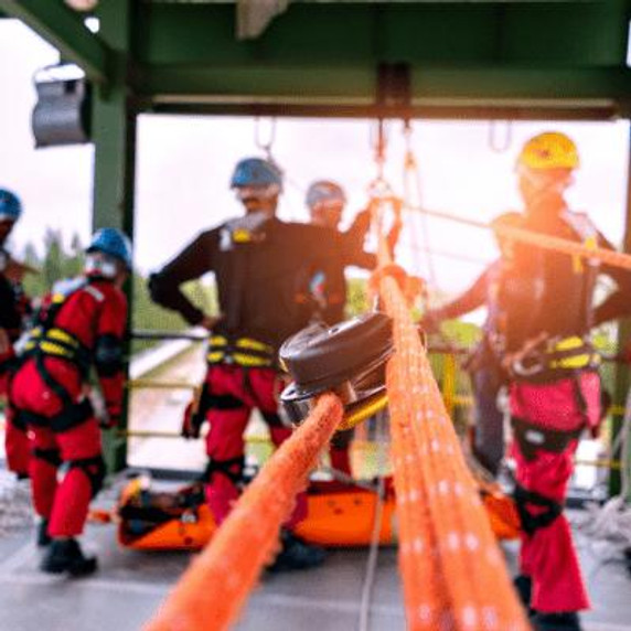 Workers wearing full fall protection PPE and have harnesses set-up.