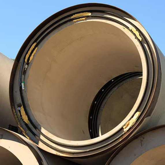 Large stack of giant bore pipes.