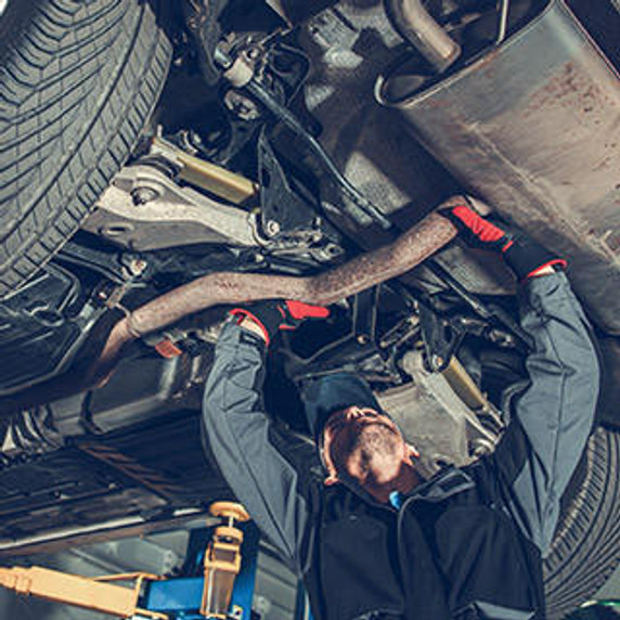 Mechanic working under car