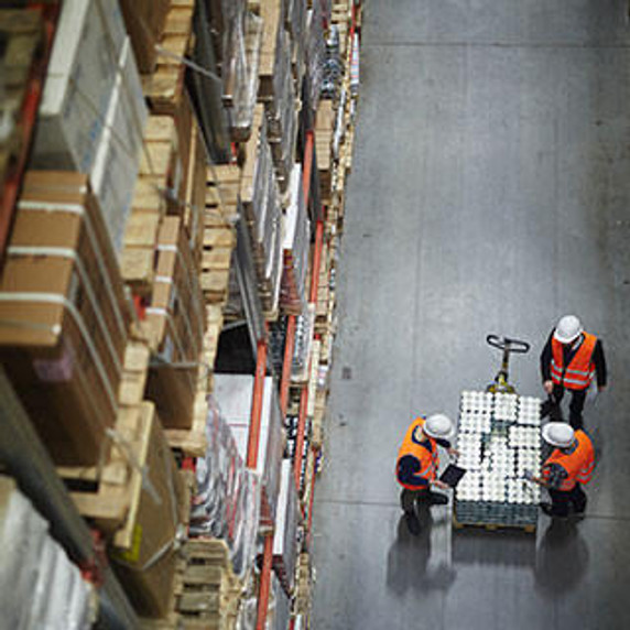 Above view of people working in large warehouse.