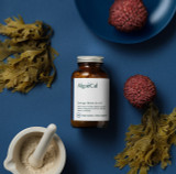 A bottle of AlgaeCal alongside raw lithothamnion superpositum algae