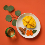 Sliced mango and turmeric on a plate