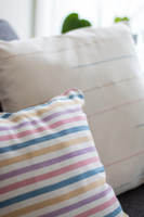 Two cosy pillows for interior decoration with natural pigments Indigo, Pink, Lilac, and Yellow