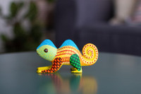 Yellow Hand carved wood Chameleon Alebrijeon a table