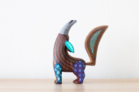 Wood carved colourful coyote on a table Alebrije