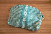 Beautiful pouch with unique patterns was made by hand using a waist loom. 
It is the perfect accessory for your cards, bills, coins, keys, or medium items. It can be used as a toiletry bag. With its ideal size, you can easily carry it on hand. Pouch aqua white