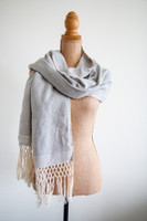 Silver Moonlight Serenity Oaxacan Shawl in soft grey and white, draped elegantly for a peaceful and sophisticated look. Indulge in tranquility with the Silver Moonlight Serenity Oaxacan Shawl. Handwoven in Mexico, this elegant grey and white wrap adds a touch of serenity to any outfit.