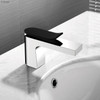 Live shot of the Lincoln Basin Mixer in chrome wave style black handle. Pictured installed on a white basin.