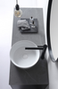 Gardinier round white semi in-set ceramic basin, live shot with black mixer, above view