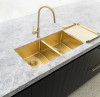 Lavello Dish Draining Tray placed outside the sink, in the brushed bronze gold.