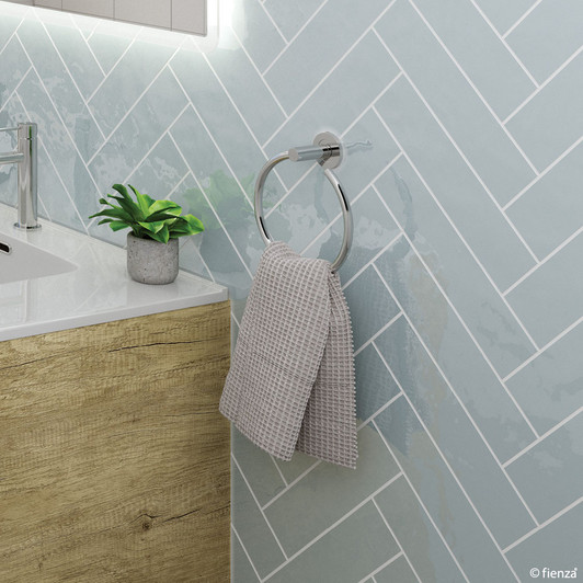 Chrome round towel ring in a sage bathroom