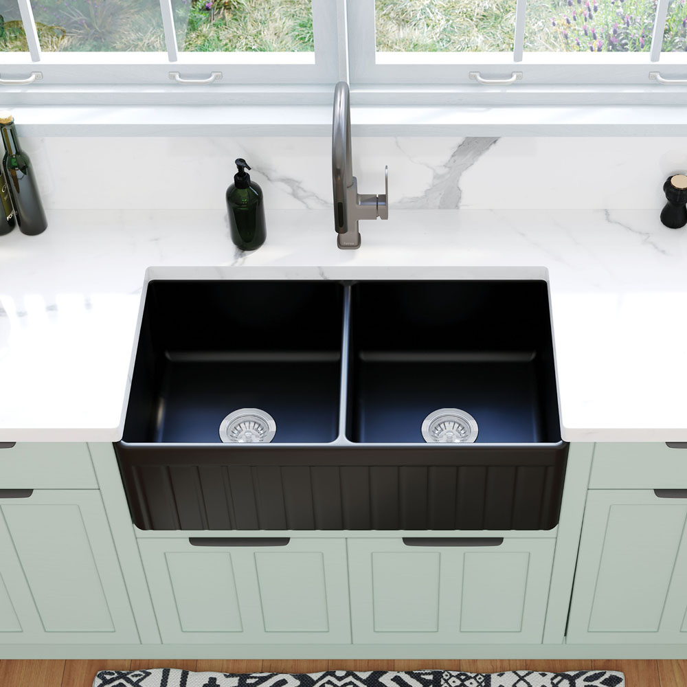 Black twin bowl farmhouse style kitchen sink with a brushed nickel mixer.