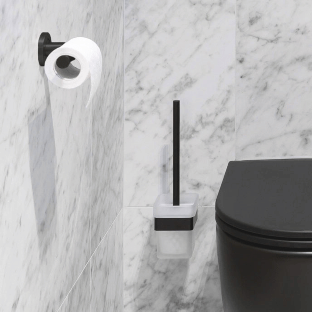 Matte black toilet roll holder and wall hung toilet brush.