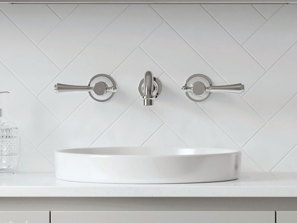 Round, chrome, lever, wall mounted tap set above a round above counter basin.