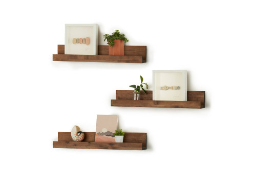 3 floating wall shelves, filled with framed artwork and decor