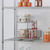 two tier cabinet organizer installed on a shelf of a wire shelving rack