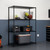 black shelving rack used in garage, filled with tool boxes and a cooler