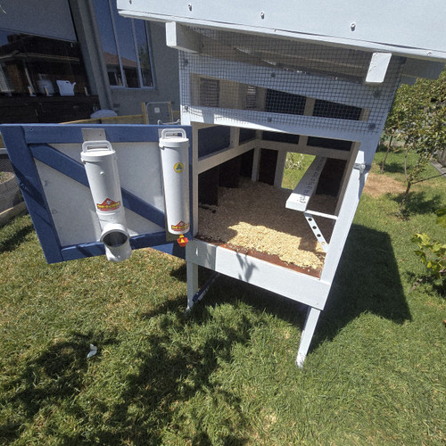 Dine-A-Chook Small Chicken Feeder and Single Cup 4 Litre Drinker mounted on the door of a backyard chicken coop