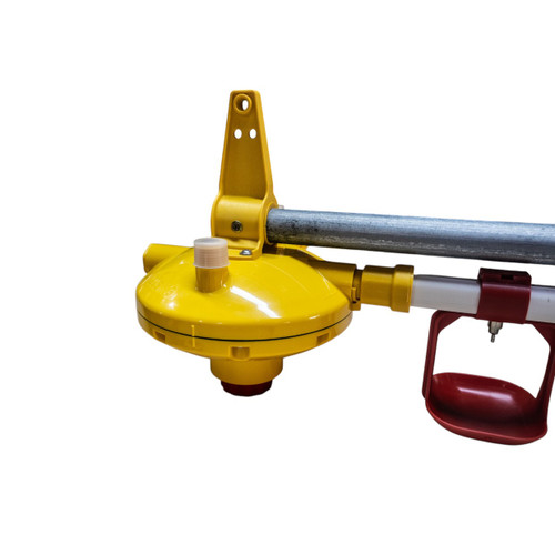 The close-up image highlights the Lubing 3202-00 Pressure Regulator integrated into a poultry drinker line. The regulator features a durable yellow housing with a 450 mm breather tube, designed to maintain consistent water pressure throughout the system. Its precision engineering ensures optimal water flow for nipple drinkers, preventing leaks and overflows. The regulator includes an easy-to-access adjustment knob for fine-tuning water pressure, making it ideal for commercial poultry operations. The sturdy mounting bracket allows secure attachment to the drinker line, while its compact design ensures seamless integration into Lubing systems.