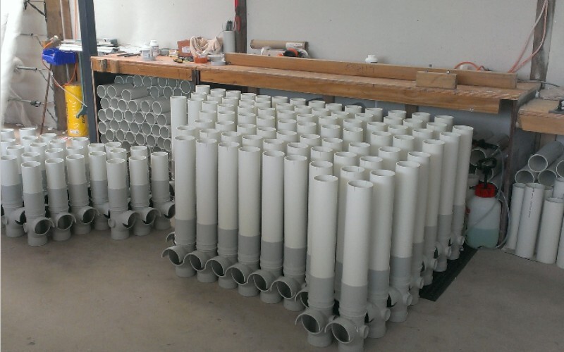 Dad assembling feeder heads in bulk batches