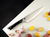 Shun Kazahana Chef 8" Knife (GPT0706) lying on a table next to sliced potatoes