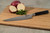 Shun Classic  8" Hollow Ground Edge Chef's Knife (DM0719) lying on a cutting board