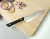 Kai Pro 6" Chef's Knife (HT7072) lying on a cutting board