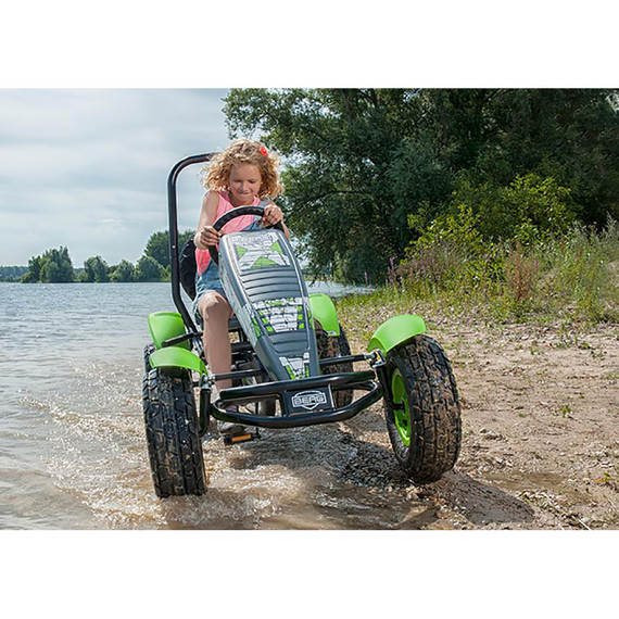 Girl cycling through part of a lake on Berg X-Plore BFR Pedal Go Kart Green (5 yrs +)