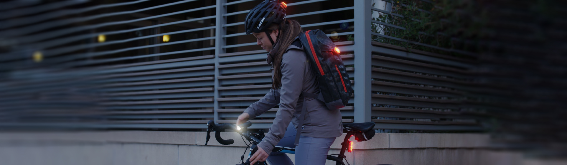 Cyclists with various lights on: front light, rear light and a wearable light on his backpack