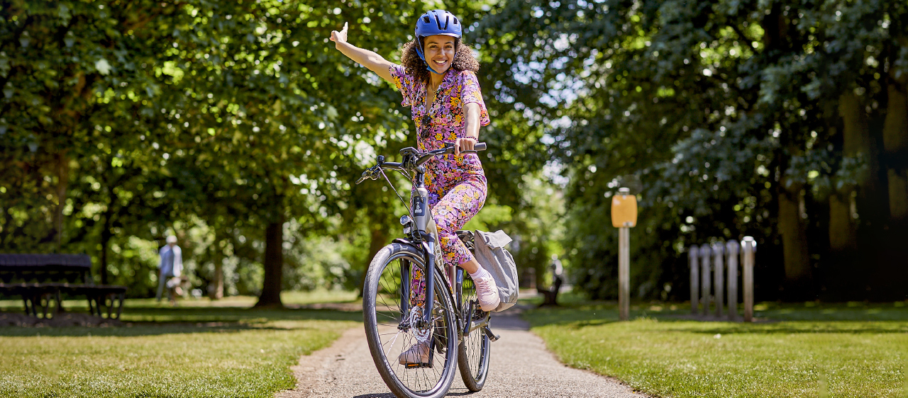 Woman enjoying cycling her electric bike in a park - Eurocycles Dublin Ireland