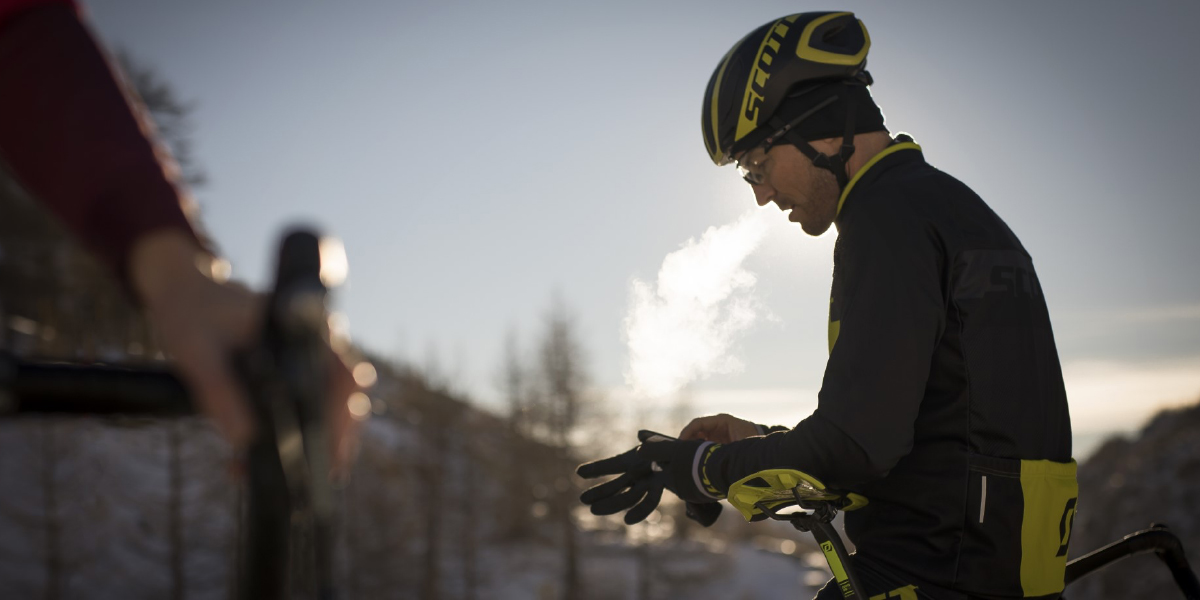 Cyclists putting on gloves on a cold day - Eurocycles Ireland