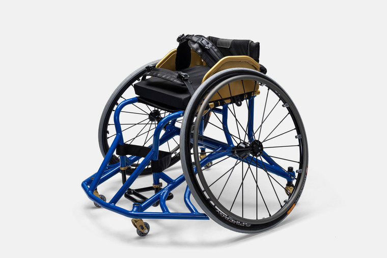 Goat Extra Tough Football and Lacrosse Wheelchair. Royal Blue Frame with Gold SideGuards and forks. Side angle view with Spinergy wheel having black hub and rim with black spokes.