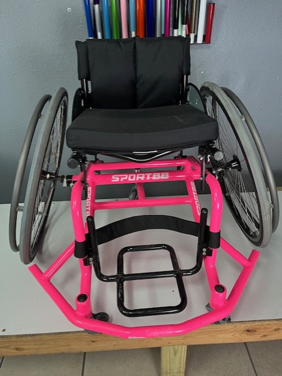 A lightly used, neon pink SportBB basketball wheelchair!